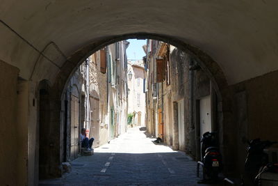 Empty alley amidst buildings in city