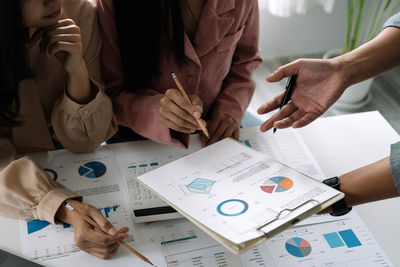 Midsection of business colleagues working at office