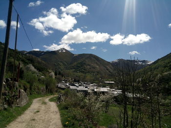 Road by mountain against sky