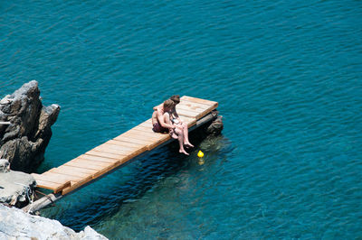 High angle view of man on pier over sea