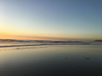 Scenic view of beach against sky during sunset