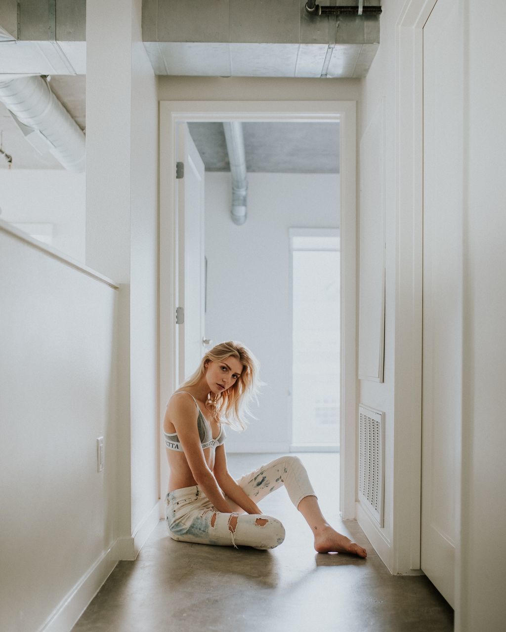 door, indoors, one person, young adult, young women, home interior, full length, real people, looking at camera, day, blond hair, sitting, smiling, lifestyles, beautiful woman, portrait, people