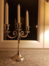 Illuminated electric lamp on table at home