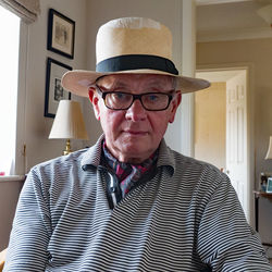 Portrait of senior man wearing hat at home