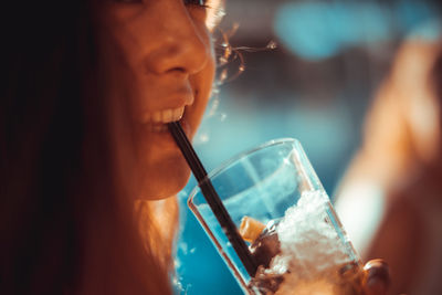 Cropped image of woman having drink