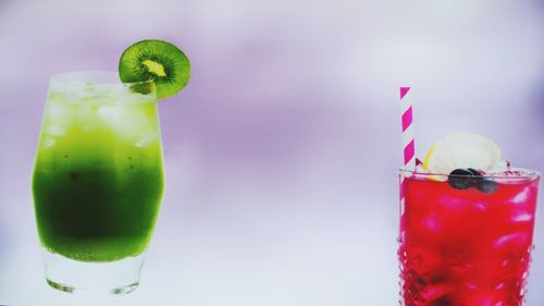 Close-up of drink on glass against white background