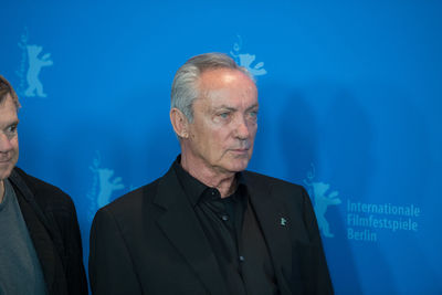 Portrait of a man against blue background