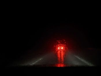 Close-up of illuminated fire against black background