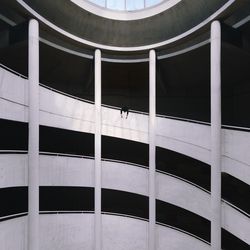 Low angle view of man hanging in balcony of building