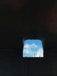 Low angle view of silhouette built structure against sky