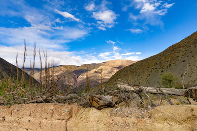 Scenic view of rocky mountains against blue sky