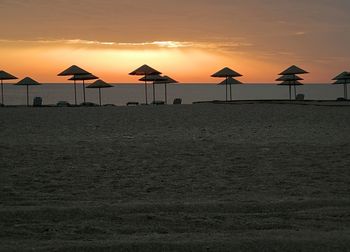 Scenic view of beach against sky during sunset