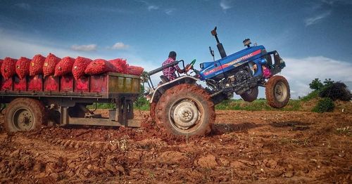 Tractor on field against sky