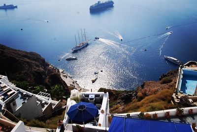 High angle view of boats sailing on sea by santorini island