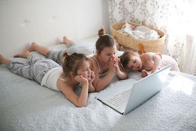 Girls funny crazy kids with laptop, concept of childhood and gadgets, life style, toning 