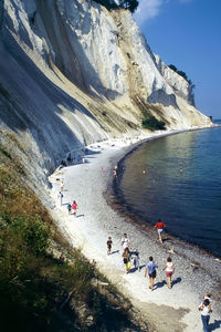 High angle view of people at beach against mountains