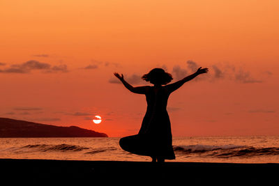 Silhouette of person in sunset, love and dancing, having fun.