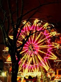 Low angle view of illuminated ferris wheel at night