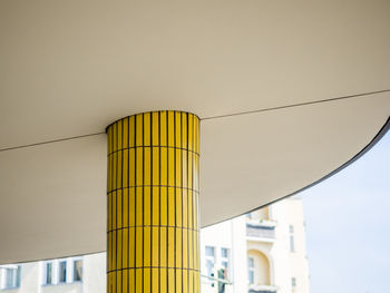 Low angle view of yellow pillar against sky