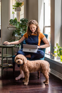 Young woman with dog at home