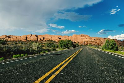 Empty road passing through landscape