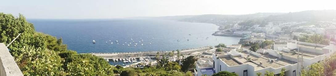 Aerial view of sea with cityscape in background