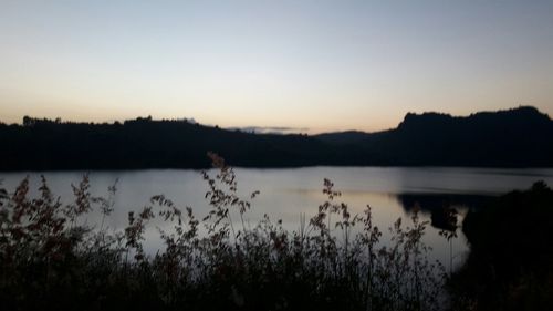 Scenic view of lake against sky during sunset