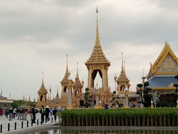 People at temple against sky