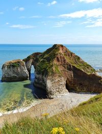 Scenic view of sea against cloudy sky