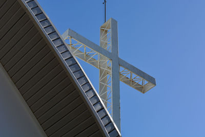 Low angle view of modern building against clear blue sky