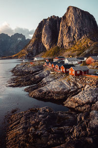 Iconic lofoten - red houses in hamnøy, mountains backdrop.