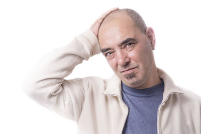 Portrait of man wearing hat against white background