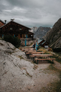 Buildings by mountain against sky