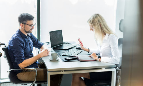 Young woman using laptop at office