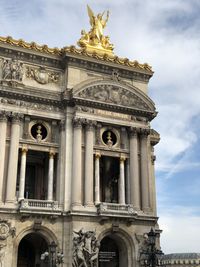 Low angle view of historical building against cloudy sky