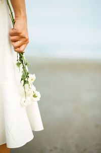 Close-up of woman holding white flower bouquet