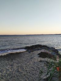 Scenic view of sea against clear sky during sunset