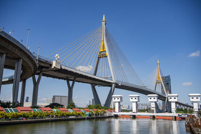 Low angle view of bridge over river against sky at night