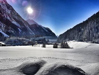 Scenic view of snow covered mountains against sky