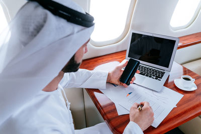 High angle view of businessman working in corporate jet