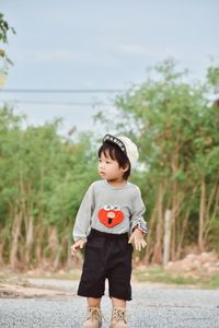 Portrait of boy walking on field
