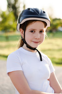 Portrait of an 11 year old girl wearing a protective bicycle helmet.
