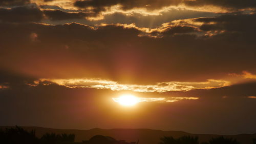 Scenic view of dramatic sky during sunset