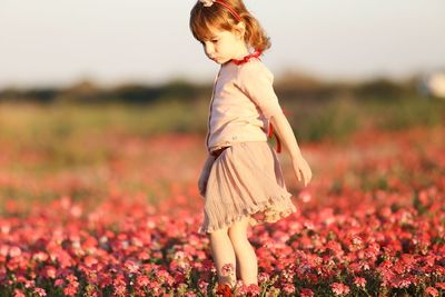 Midsection of woman standing on field