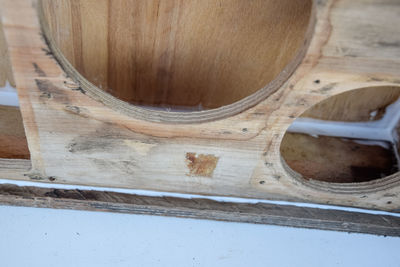 High angle view of rusty metal on wooden table