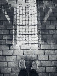 Low section of man standing on staircase