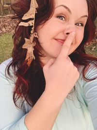 Portrait of playful woman making face at yard