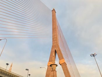 Low angle view of bridge against cloudy sky