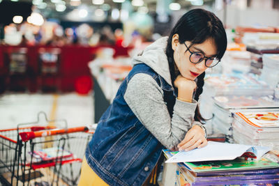 Young woman looking at book