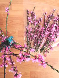 High angle view of pink flowering plant on wooden table